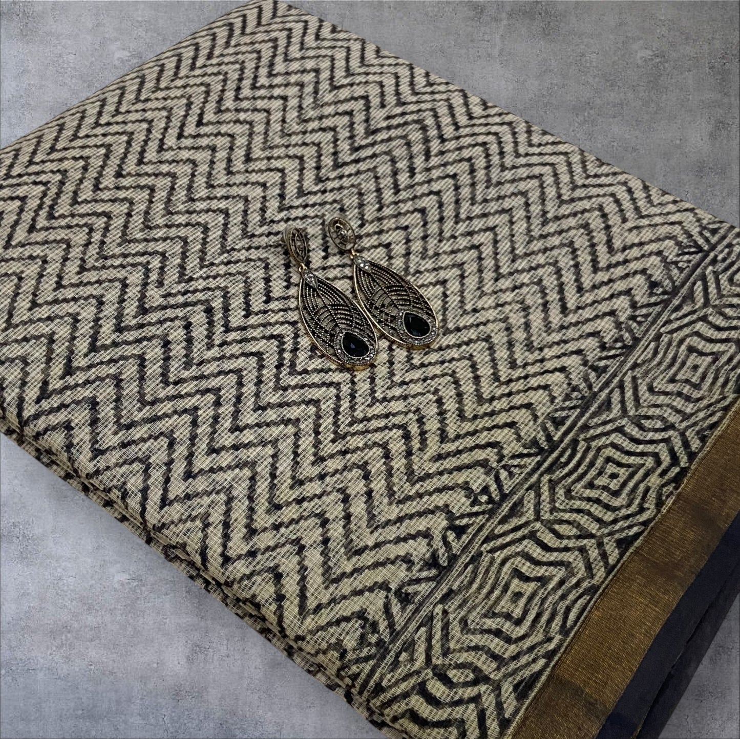 Wavy printed black cotton kota doria zari border saree