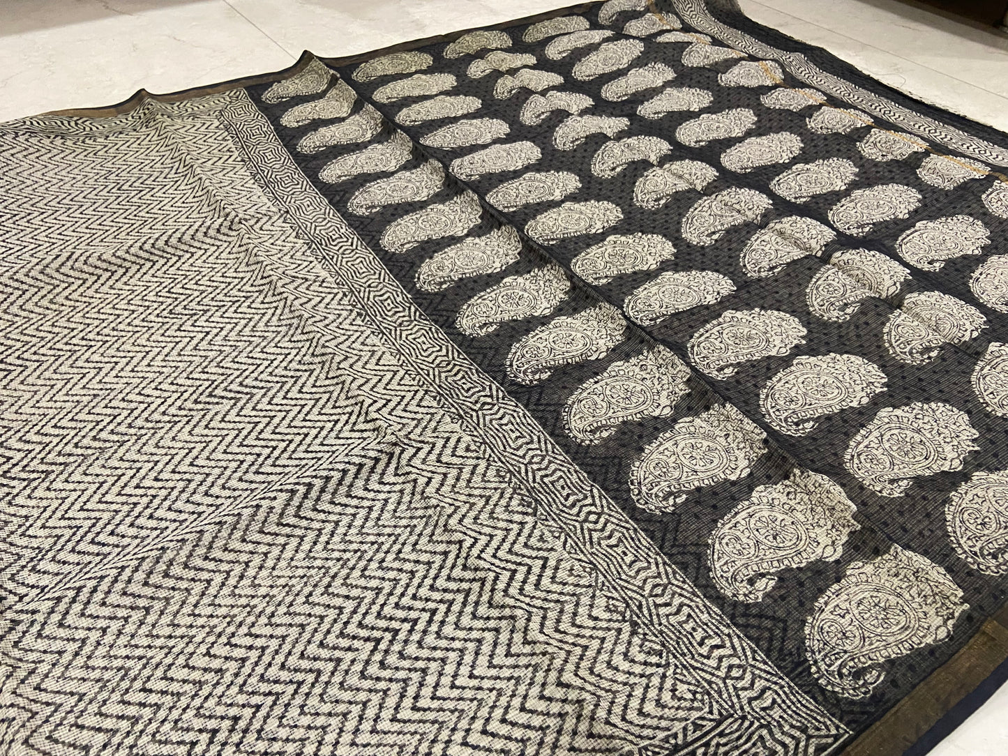 Wavy printed black cotton kota doria zari border saree
